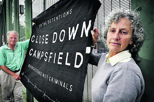 Campaigner Liz Peretz at protest in front of Campsfield House with banner including slogan "Close Down Campsfield"