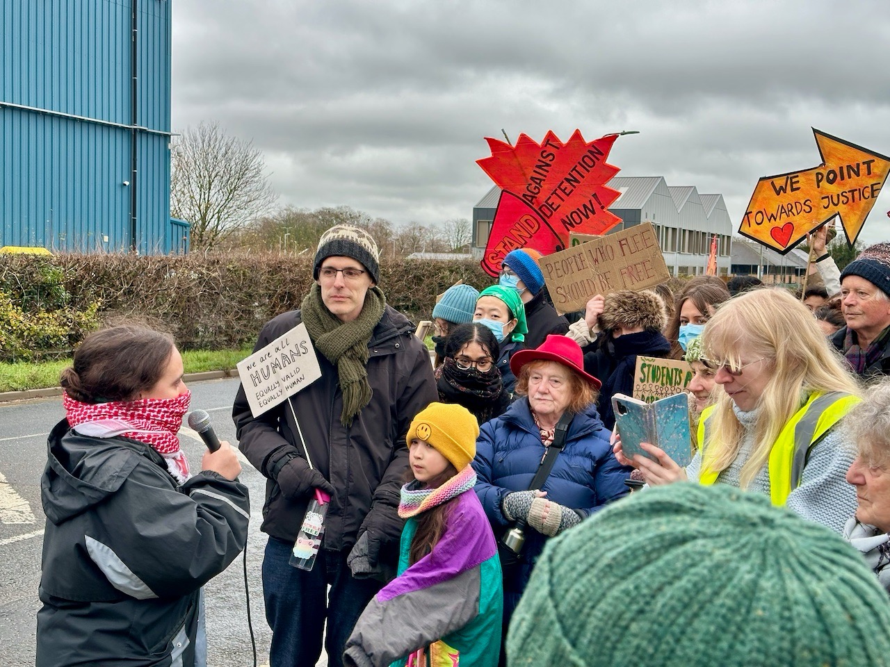 A speaker from Oxford STAR addresses protesters outside Campsfield House