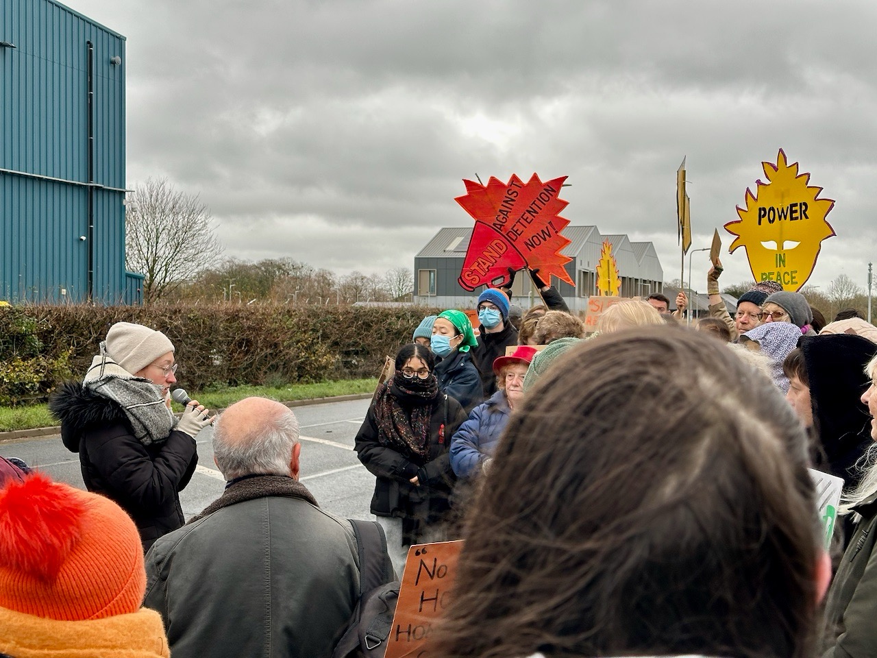 Hari Reed, co-director of Asylum Welcome, Oxford's refugee support charity, addresses protesters outside Campsfield House