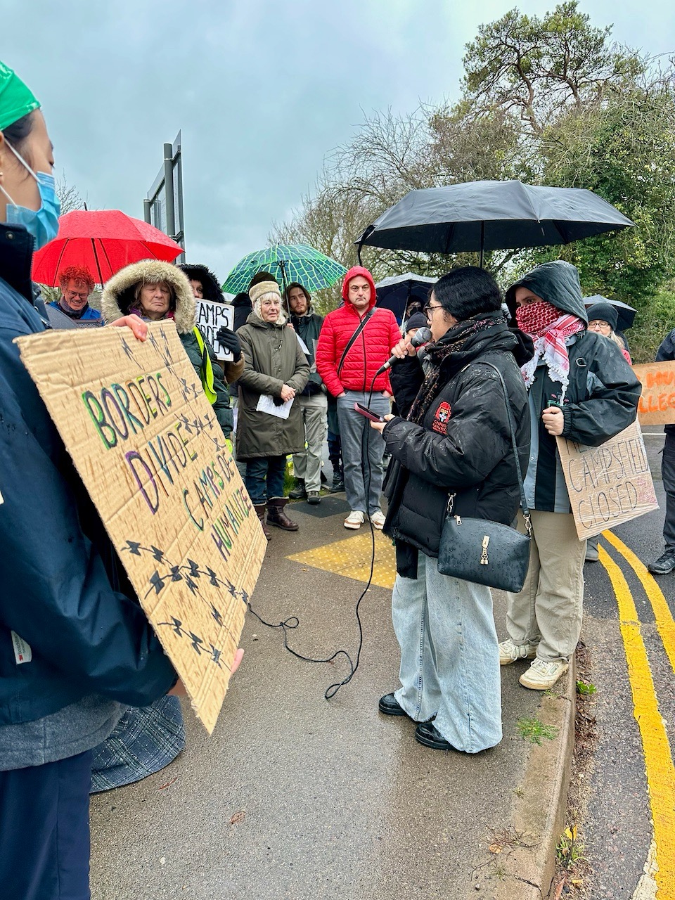 An Oxford student performs a poem of solidarity for protesters outside Campsfield House