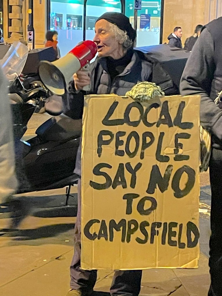 Coalition organiser Liz Peretz with megaphone and placard reading "Local people say NO to Campsfield"