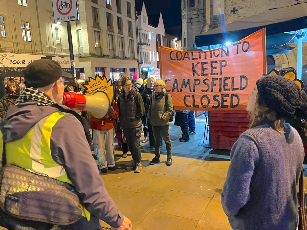 Coalition supporters gathered at Carfax with banner and placards and Kidlington resident with megaphone leading a chant.