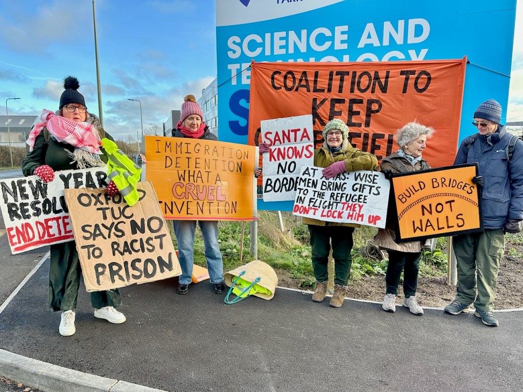 Using placards to communicate with passersby at the demonstration outside Campsfield on 27 December 2025