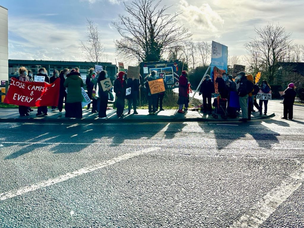 Close Campsfield supporters, including some Your Party members, gather on Langford Lane, Kidlington, on the corner of the approach road to Campsfield House.