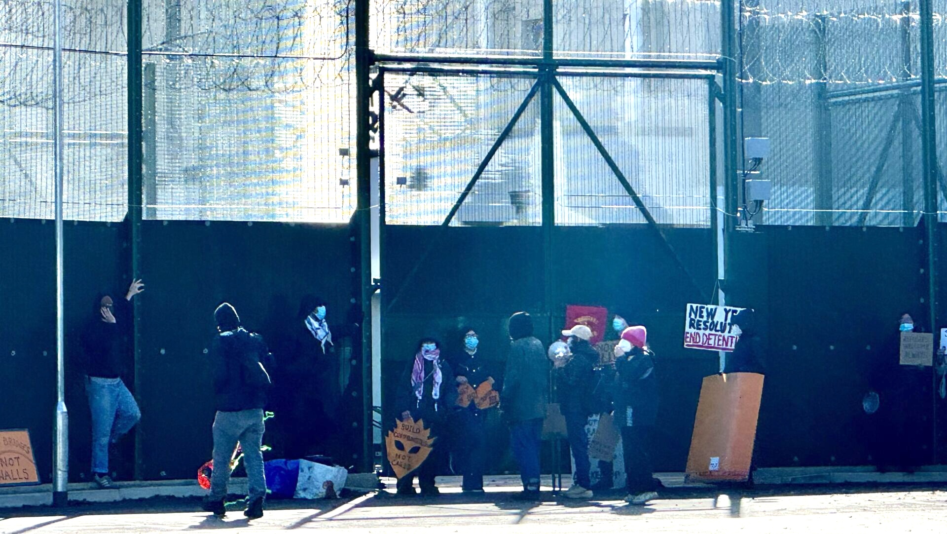 A group of Coalition to Close Campsfield supporters with placards protesting just outside the IRC gates on the site grounds on 28 February 2026 (Image credit: Mercedes Haas for Cherwell)