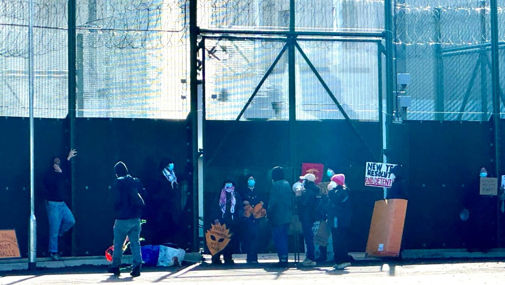 A group of Coalition to Close Campsfield supporters with placards protesting just outside the IRC gates on the site grounds on 28 February 2026 (Image credit: Mercedes Haas for Cherwell)