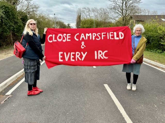 29 March, 2026: Close Campsfield campaigners holding banner reading "Close Campsfield & every IRC" (Photo: Geoff Taylor)