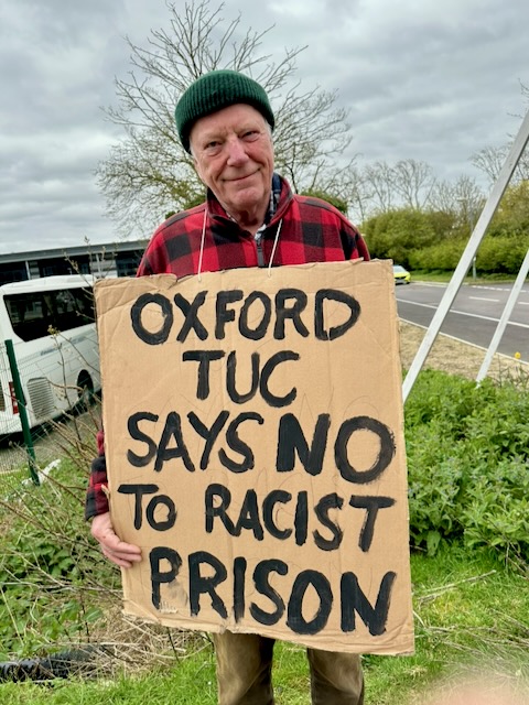 29 March, 2026: Close Campsfield campaigner holding placard reading "Oxford TUC says no to racist prison" (Photo: Geoff Taylor)