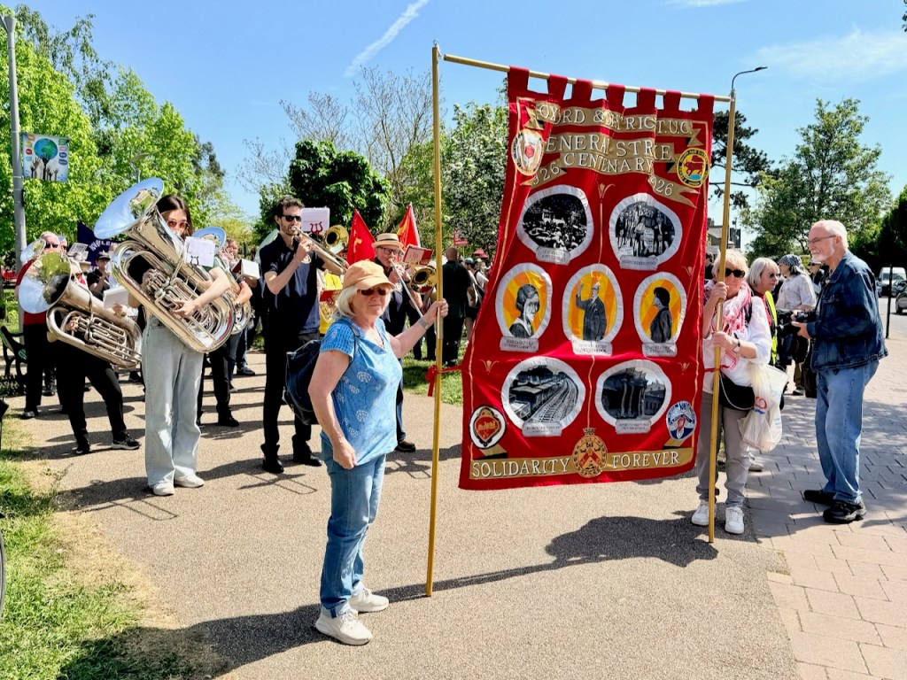 Oxford & District Trades Council banner celebrating the centenary of the 1926 General Strike, at the front of the march, with a brass band behind