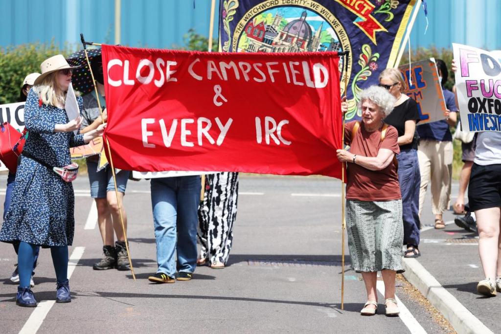 Coalition to Close Campsfield protestors, with a "Close Campsfield & every IRC" banner and the Oxford & District Trades Union Council banner, march towards the Immigration Removal Centre in Kidlington, Oxfordshire (Photo: Ed Nix)