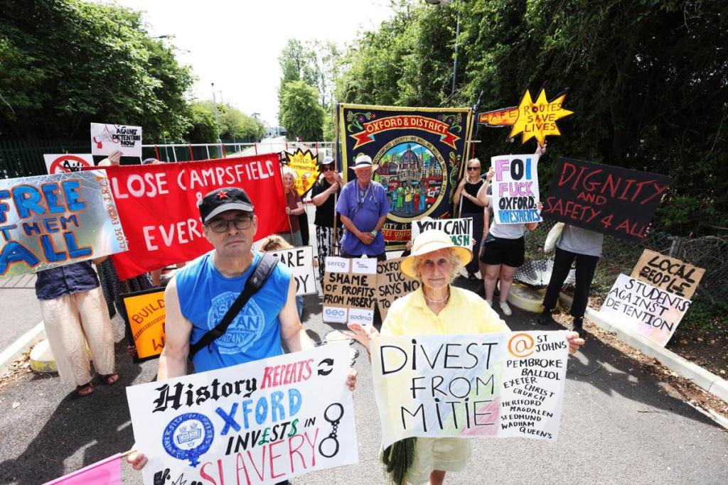 Around 20 protestors, with placards and banners, including the Oxford & District Trades Union Council banner, near the entrance to Campsfield House IRC in Kidlington, protesting over 'slave labour' wages paid to its detainees (Photo: Ed Nix)