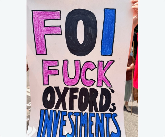 Placard reading "FOI. Fuck Oxford's investments"
